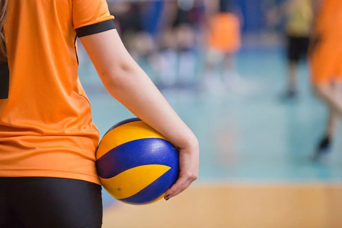 Player holding volleyball against waist