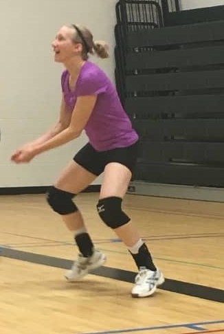 female volleyball player getting ready to pass the volleyball