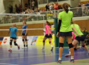 Player standing on the side of the court, watching the game