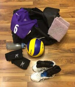 Volleyball gear: jersey, sweat towel, water bottle, volleyball, knee pads, shoes, ankle braces, duffel bagVolleyball gear