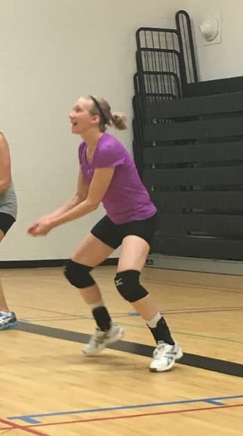 female volleyball player bumping the volleyball