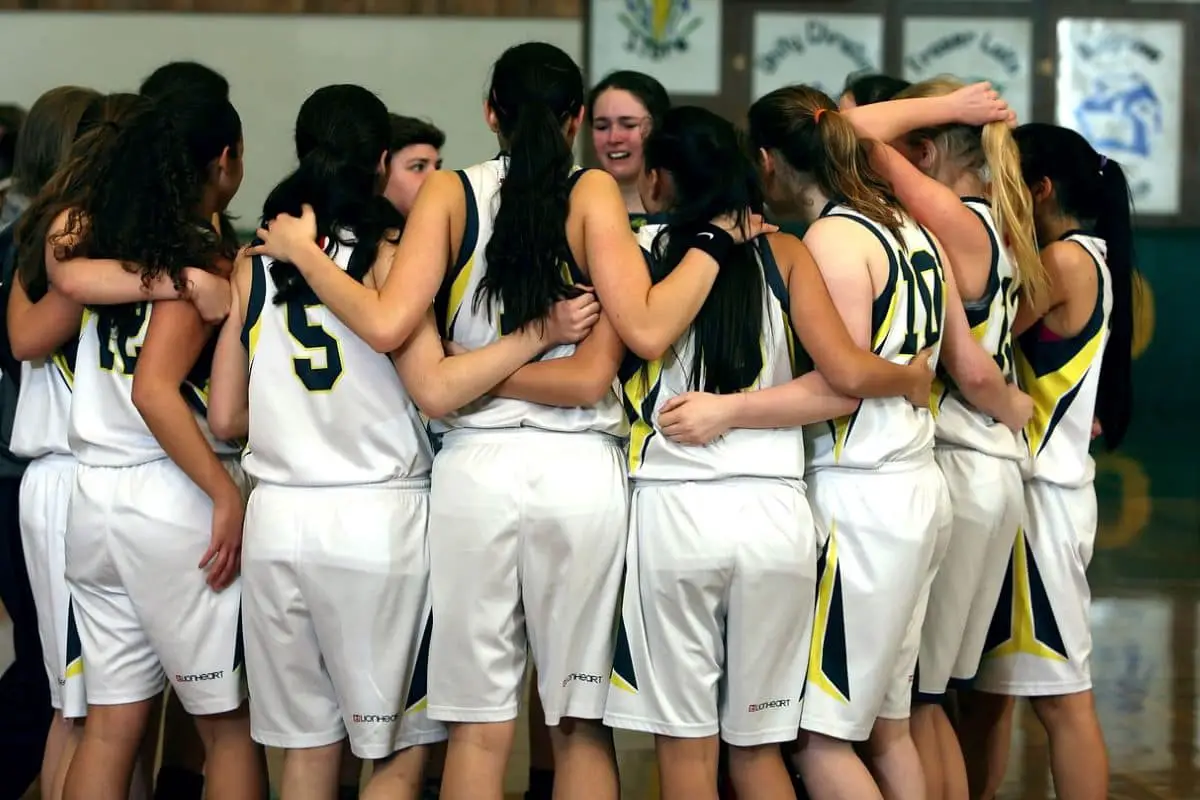 Woman's sports team in a huddle