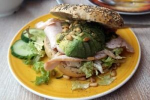 bagel with avocado and turkey on a plate