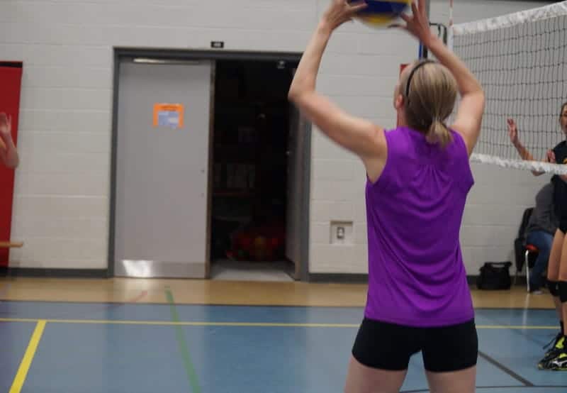 female player setting the volleyball