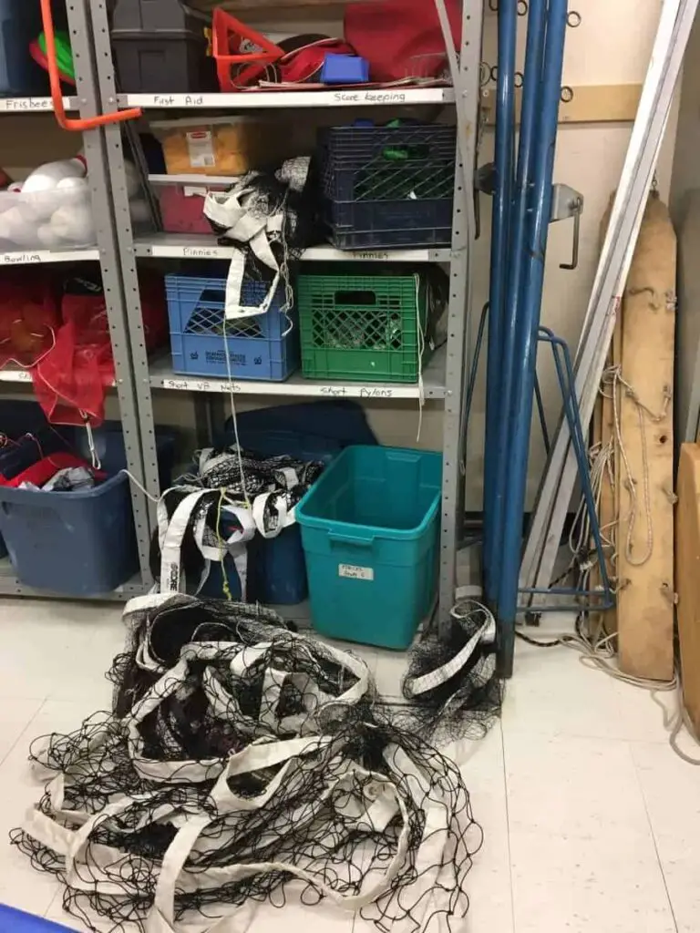 volleyball net tangled up on floor of sports equipment room