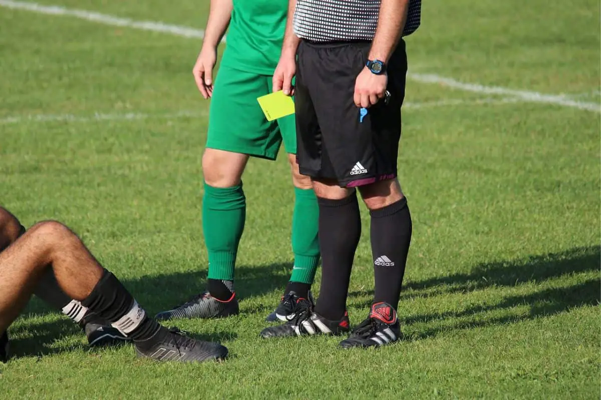 Referee giving a yellow card