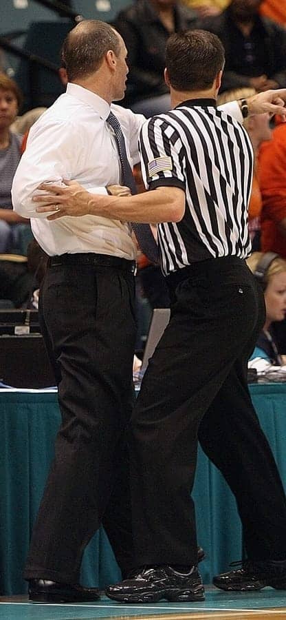 ref holding back coach