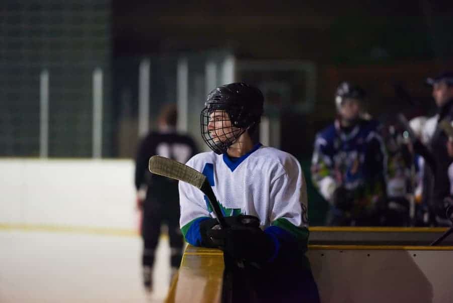 hockey player watching from the bench