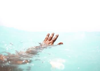 arm in clear water with hand reaching out