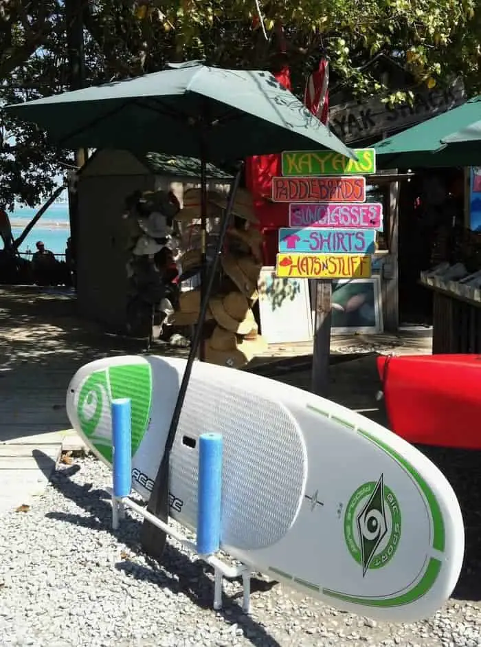 paddleboard laying sideways under an umbrella