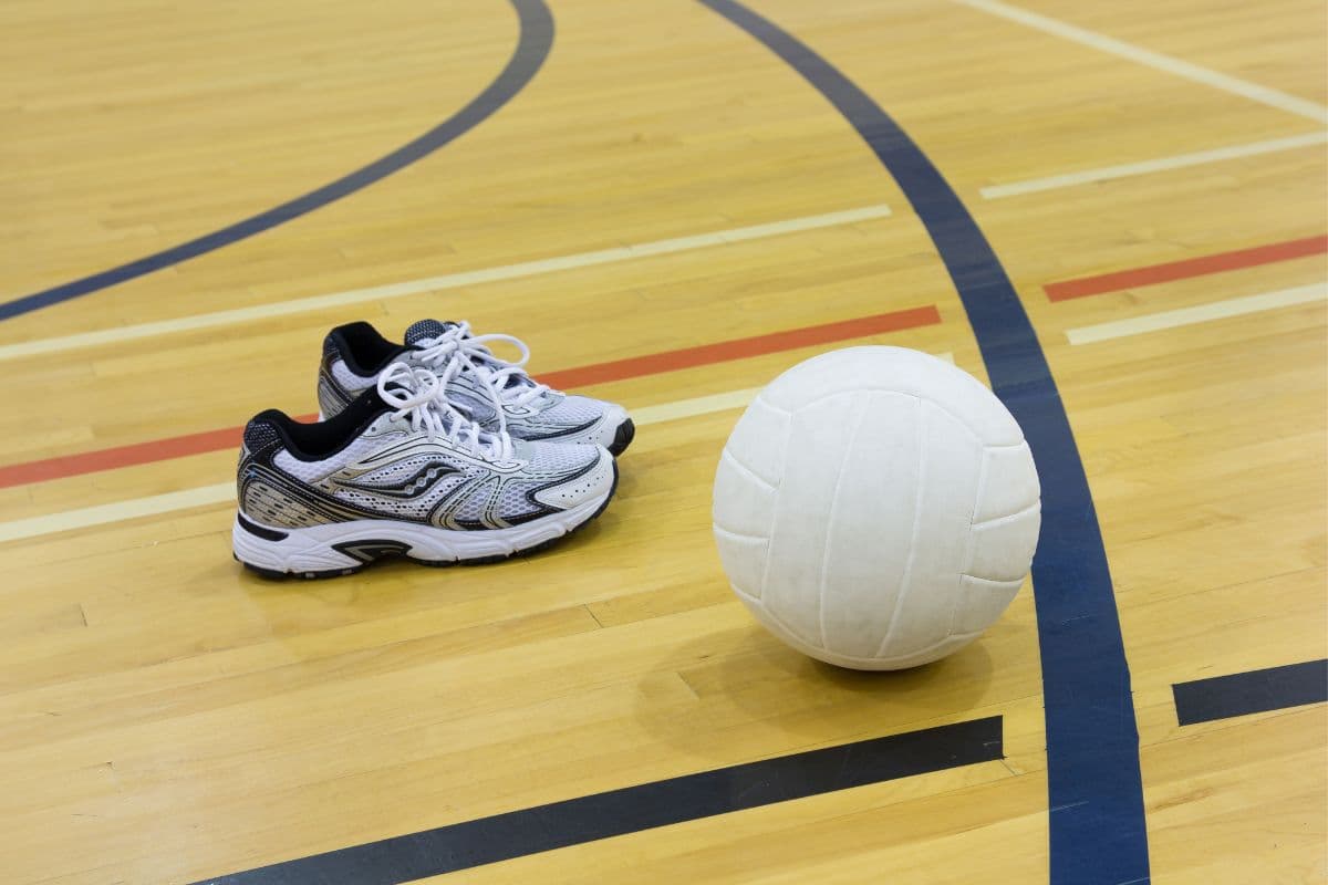 Pair of volleyball shoes and ball