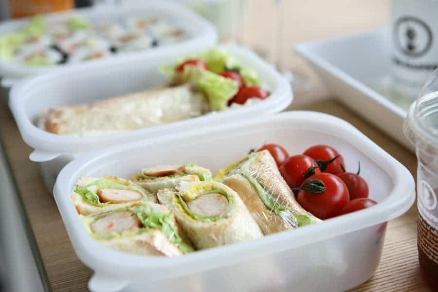 variety of sandwiches and wraps in different plastic containers