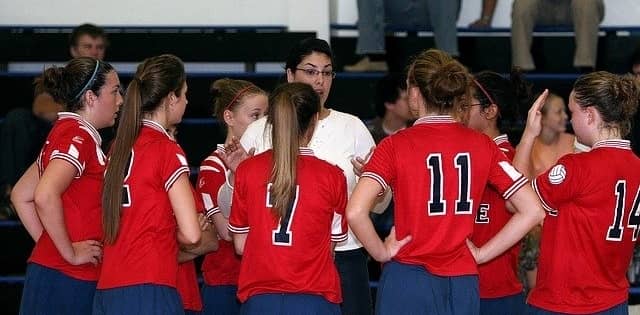 Coach talking to volleyball team
