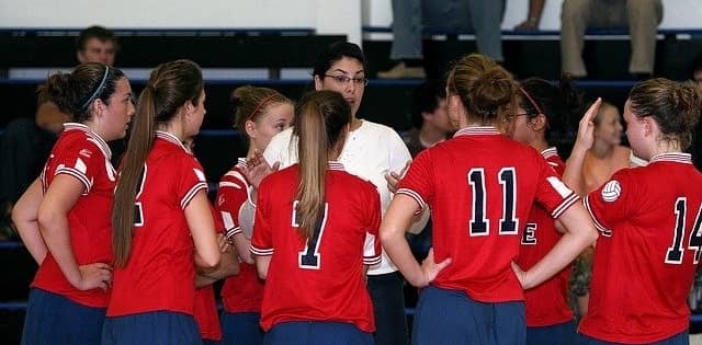 Coach talking to team mates 