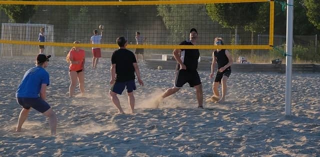 People playing beach volleyball