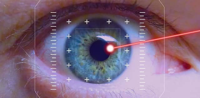Eye with a red laser hitting it