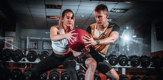 Two people working out with a medicine ball