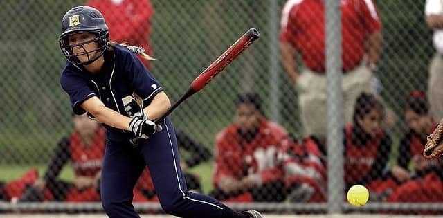 Softball player hitting a ball