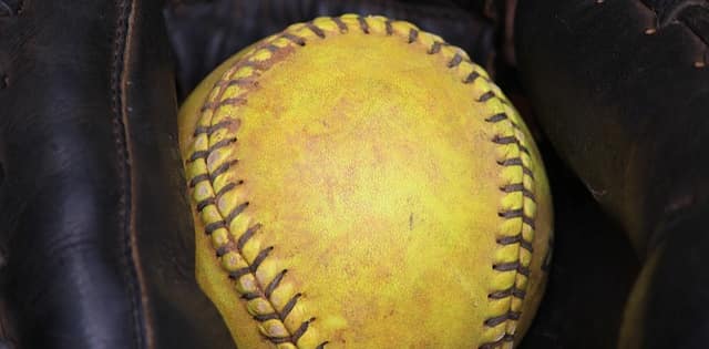 A softball in a softball glove