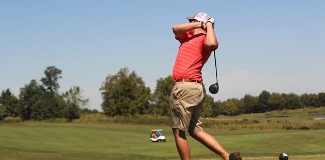 Golfer swinging a golf club