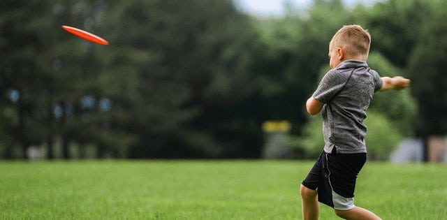 Kid throwing a frisbee